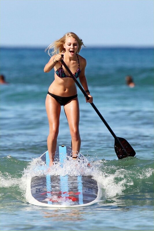 Woman paddleboarding in ocean