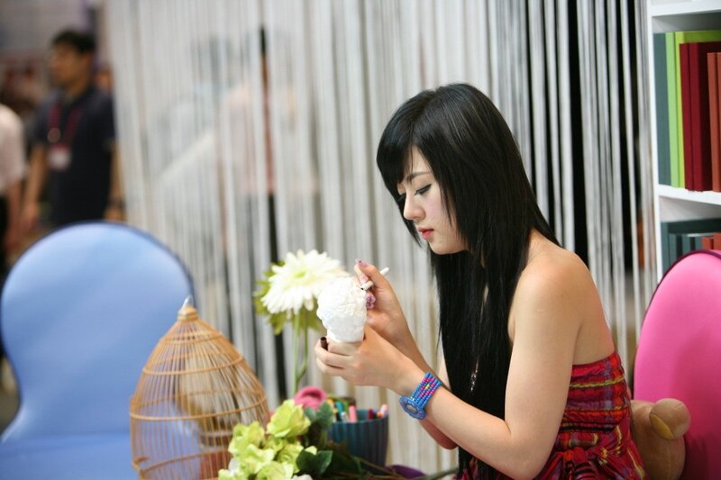woman painting a sculpture