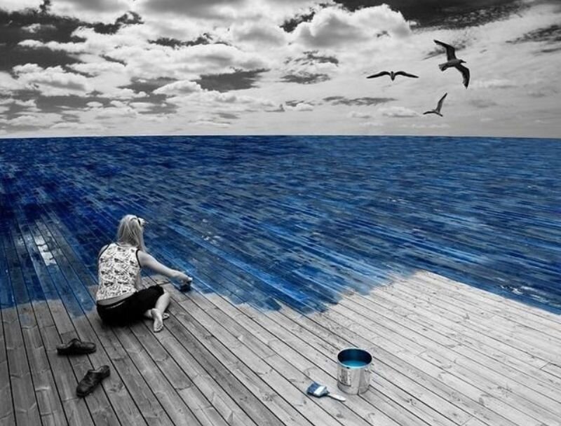 Woman painting ocean on dock