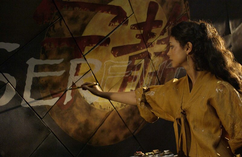 woman painting on a large surface