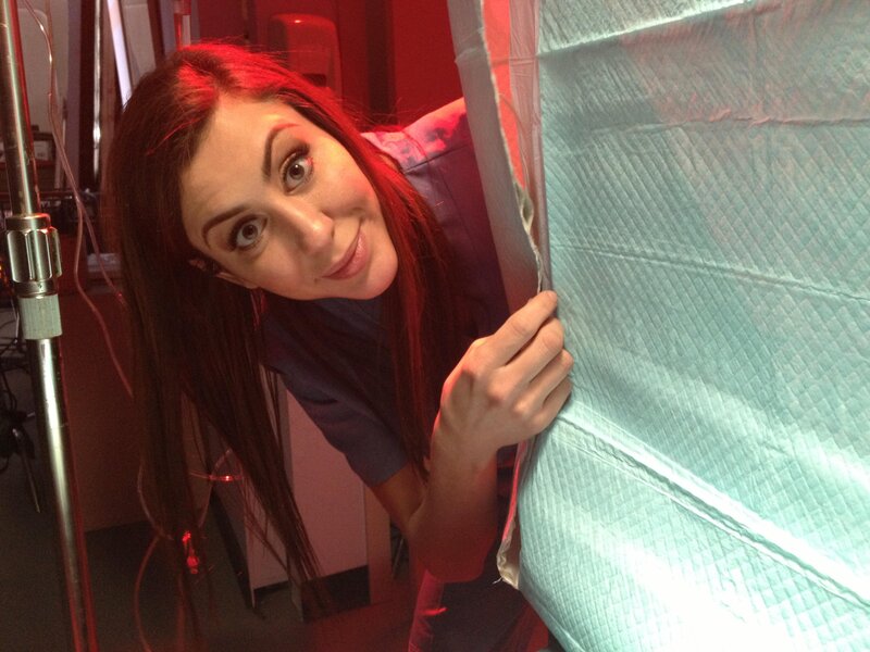woman peeking behind curtain