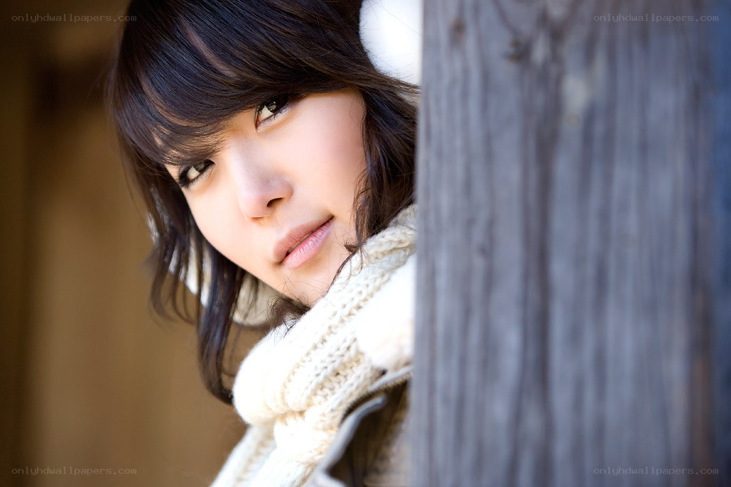 woman peeking from behind a post