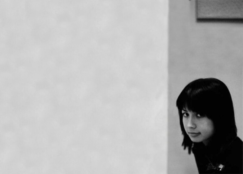 woman peeking from behind a wall
