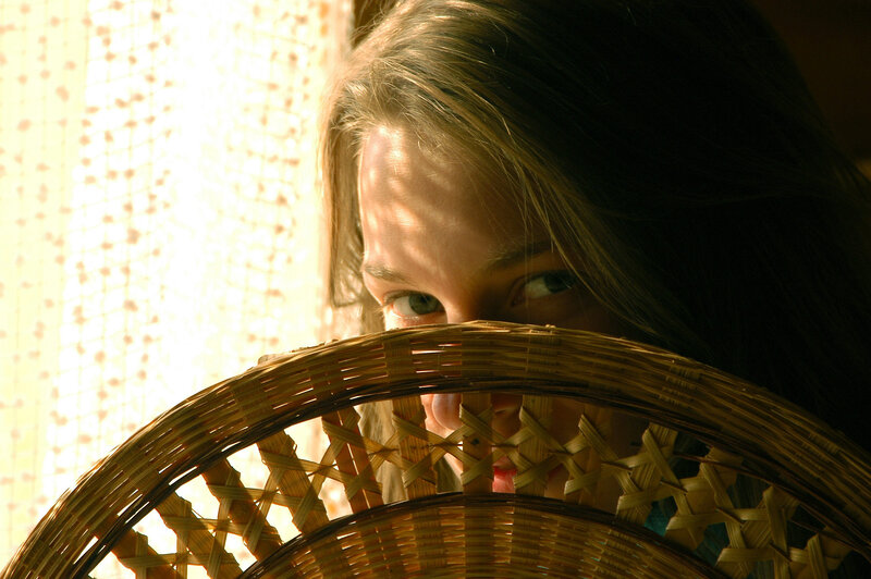 woman peeking from behind basket