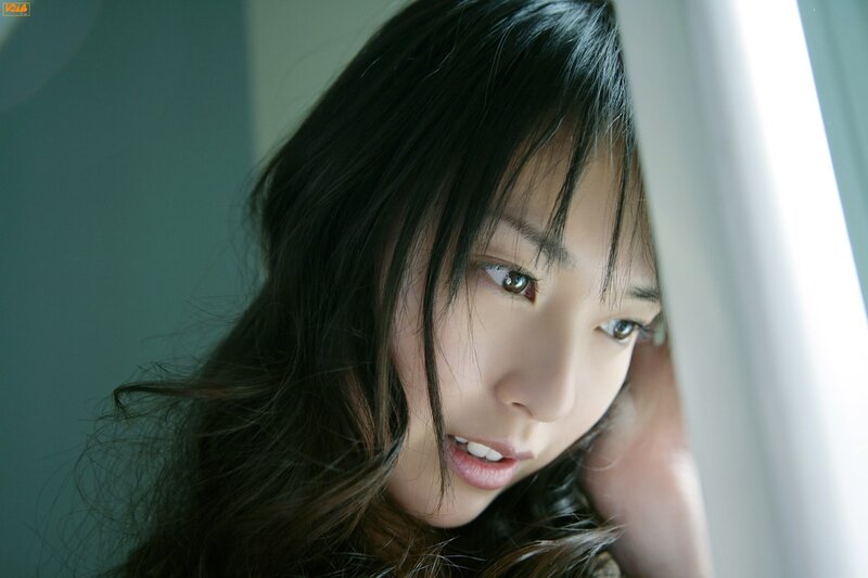 woman peeking from behind curtain