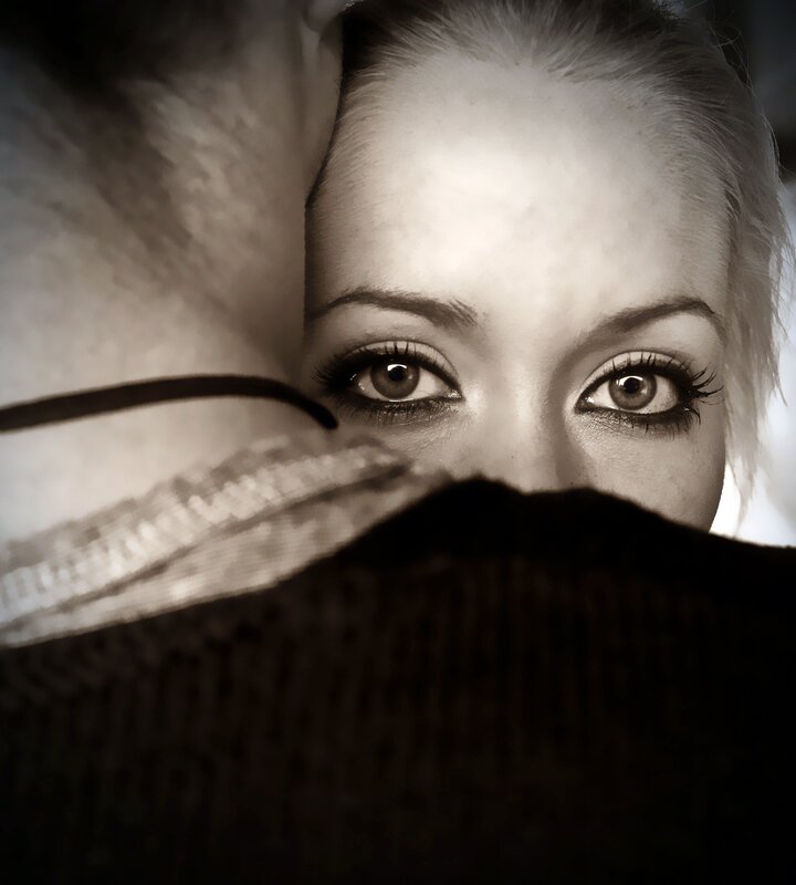 woman peeking from behind fabric