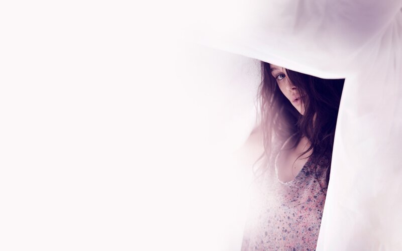 woman peeking from behind fabric