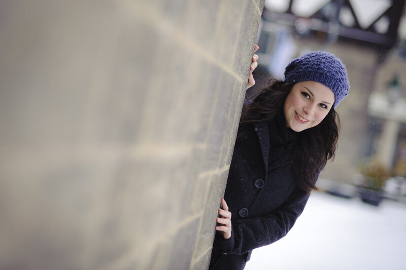 woman peeking from behind wall