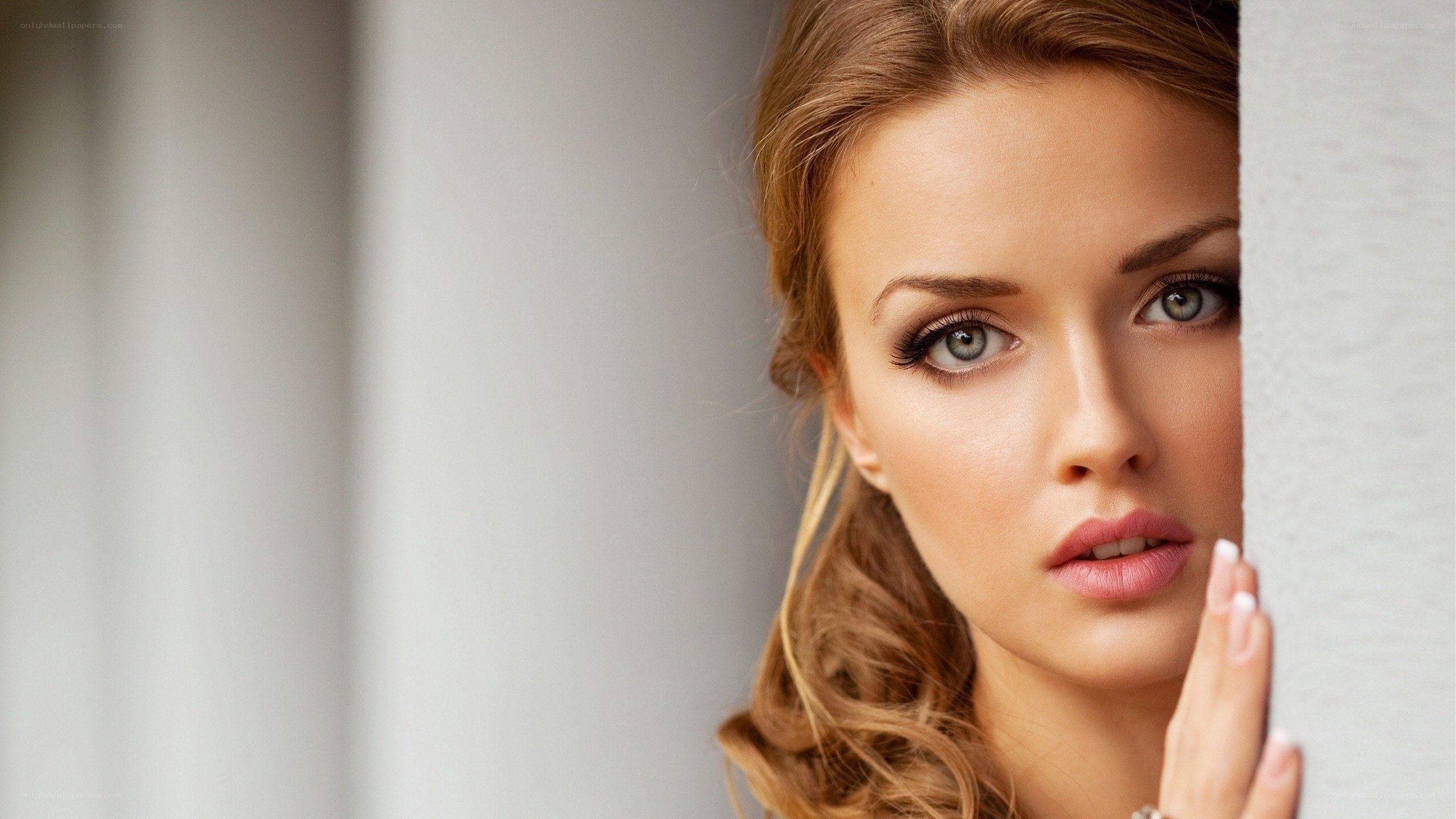 woman peeking from behind wall
