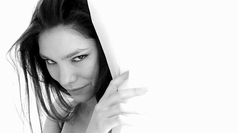 woman peeking from behind white surface