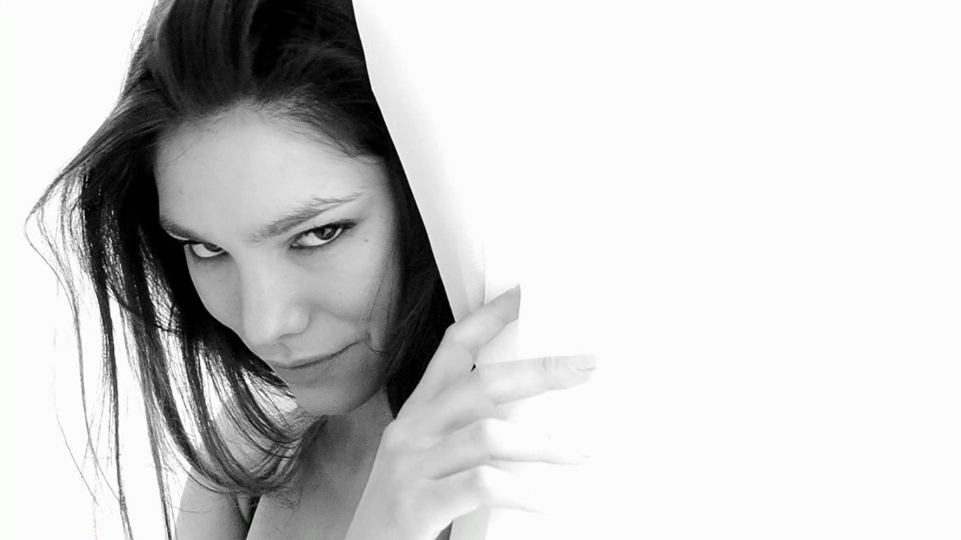 woman peeking from behind white surface