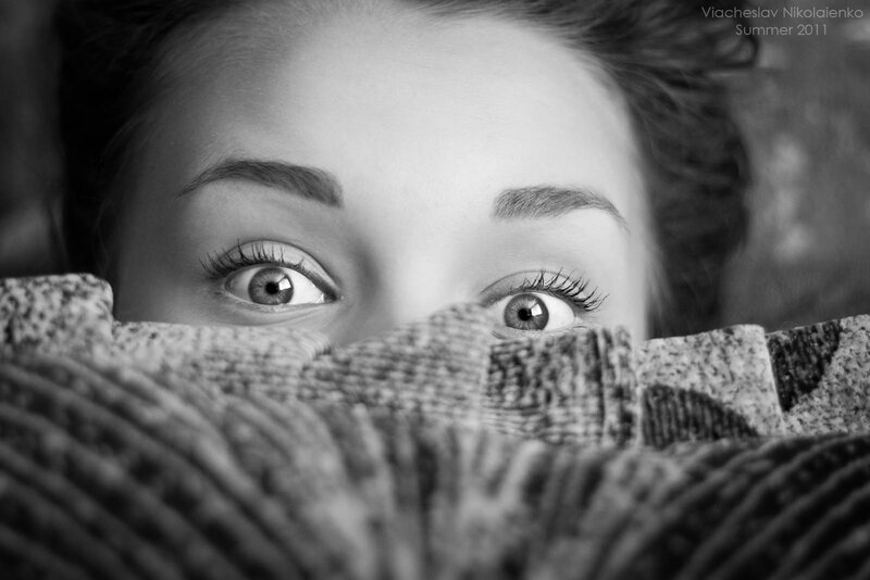 Woman Peeking from Blanket