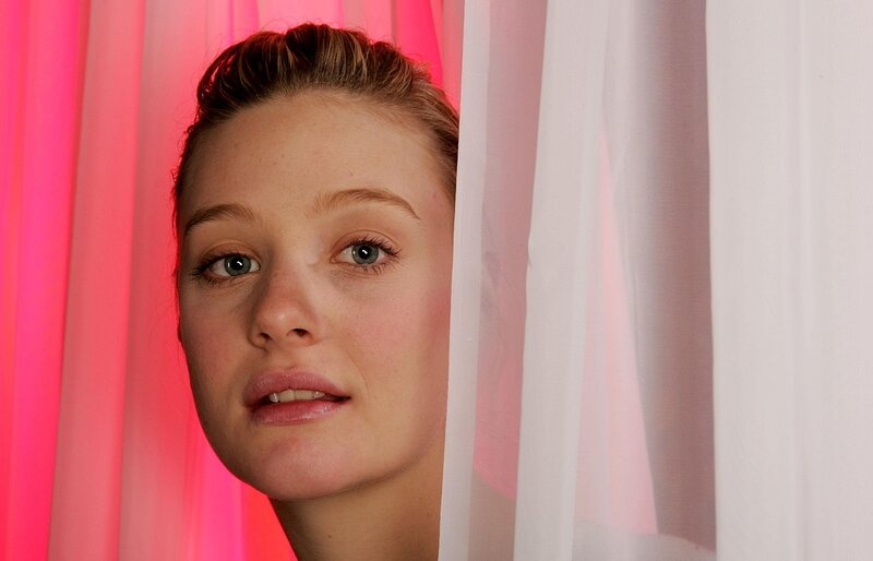 Woman Peeking from Curtain