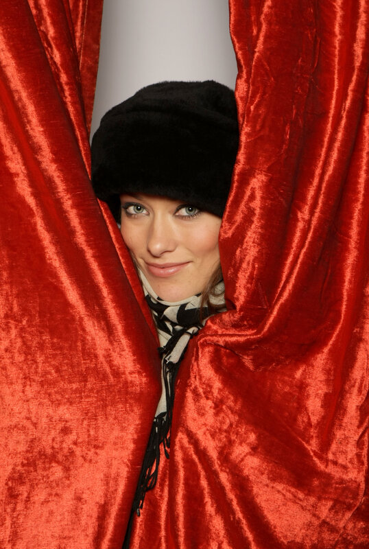 woman peeking from red curtain