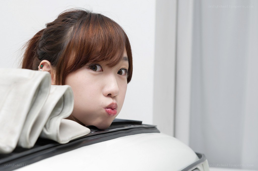 woman peeking from suitcase
