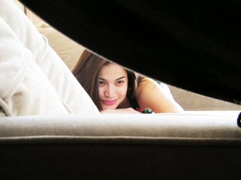 woman peeking from under a blanket