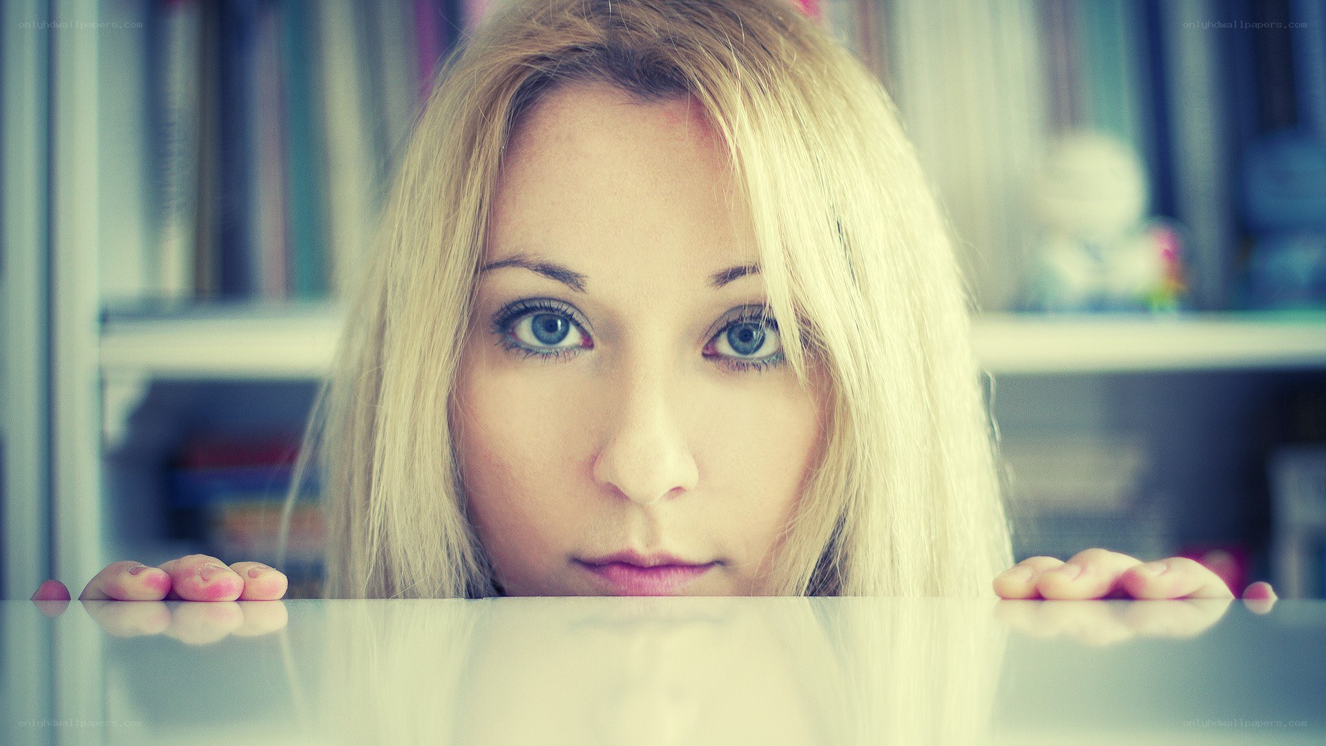 woman peeking over a table