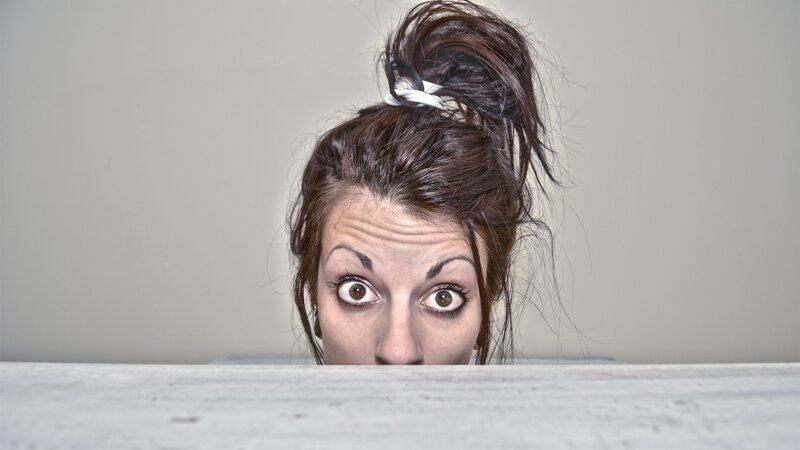 woman peeking over edge
