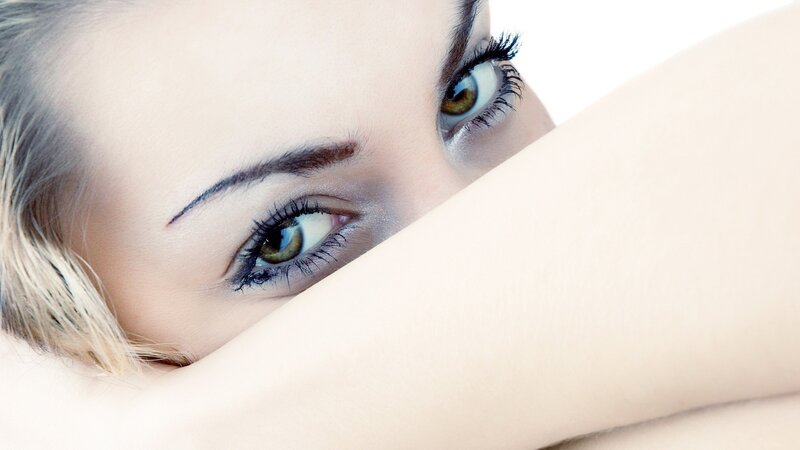 woman peeking over her arm