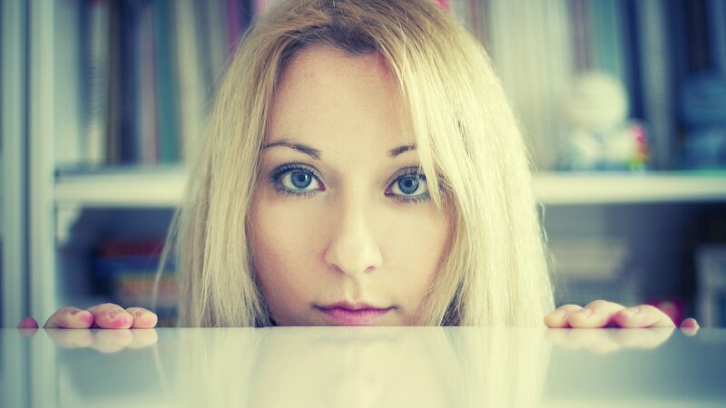 woman peeking over table