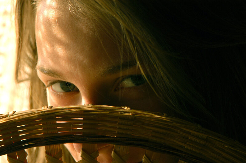 woman peeking through basket