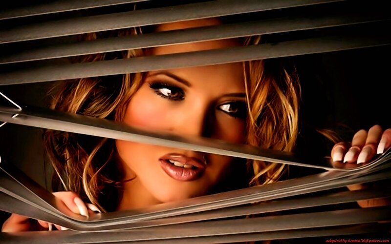 woman peeking through blinds
