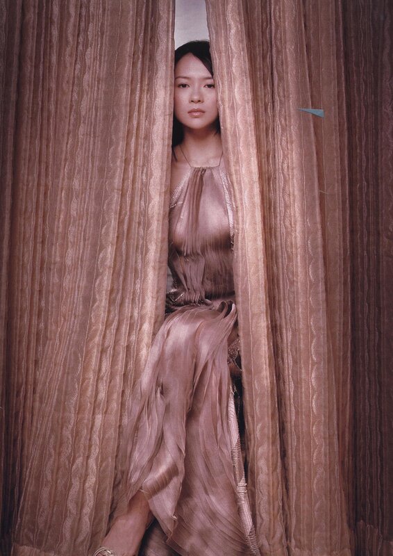 woman peeking through curtains