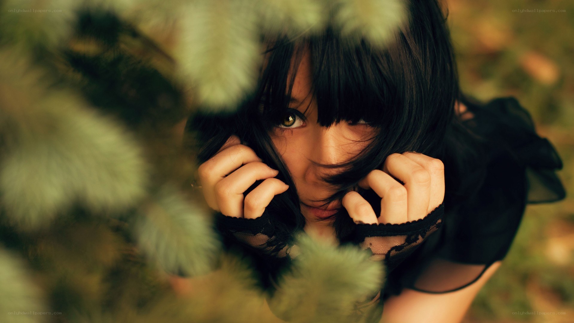 woman peeking through foliage