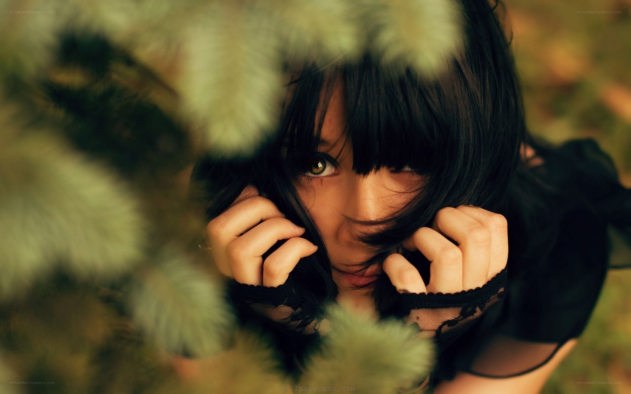 woman peeking through foliage