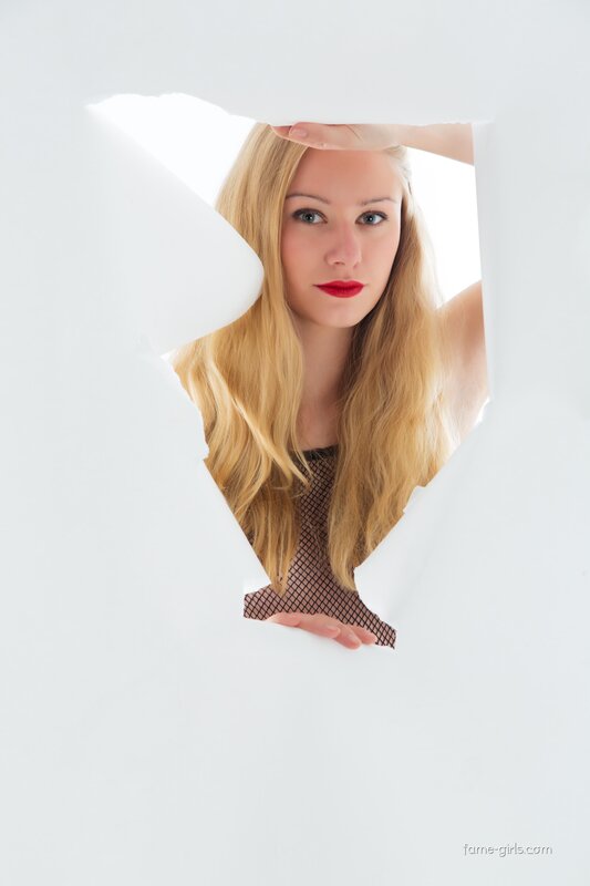 woman peeking through paper hole