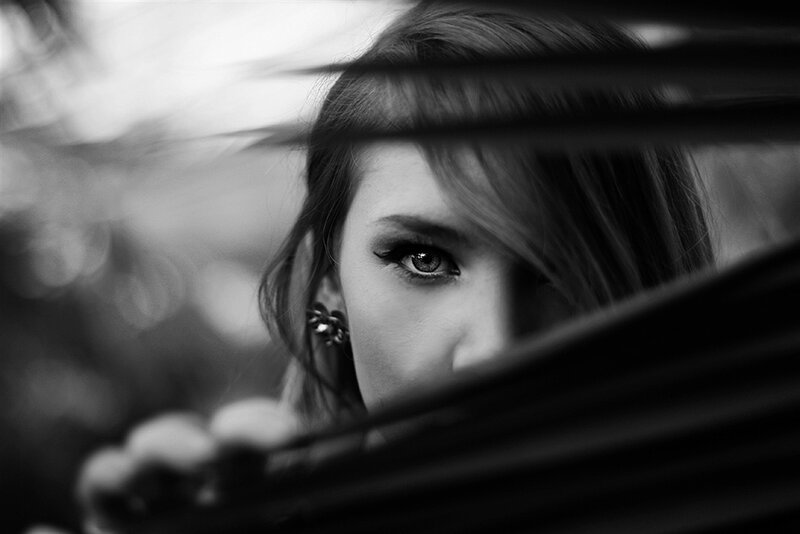 Woman Peeking Through Slats