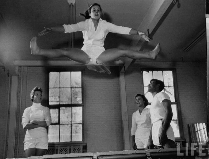 Woman performing acrobatics on trampoline
