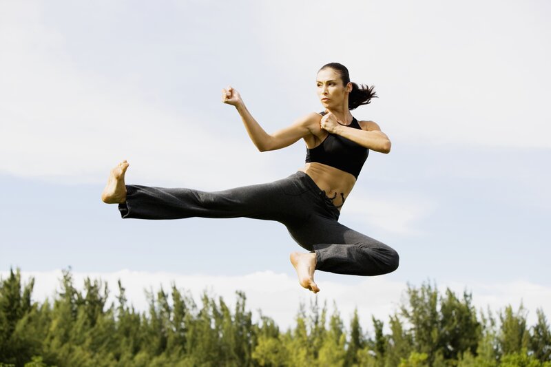 woman performing martial arts kick