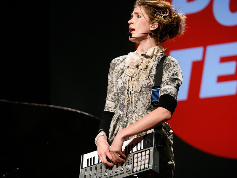 woman performing on stage with keyboard