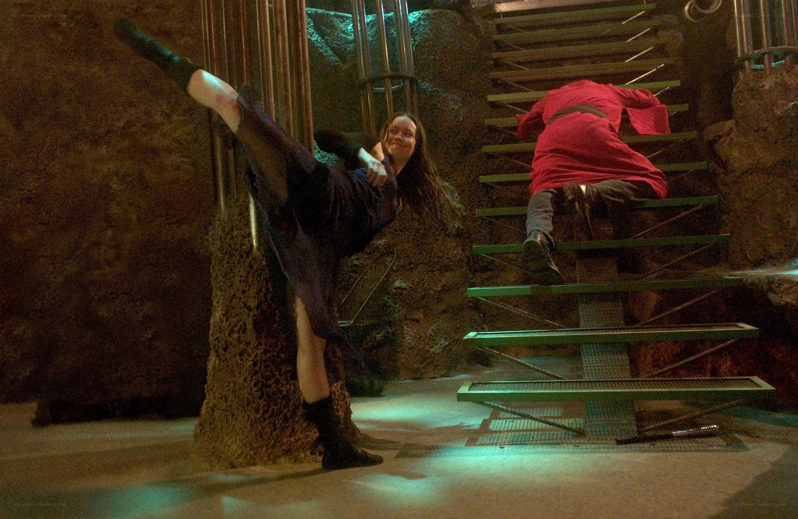 Woman performs high kick in action scene