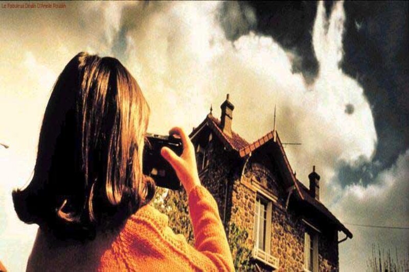 woman photographing house