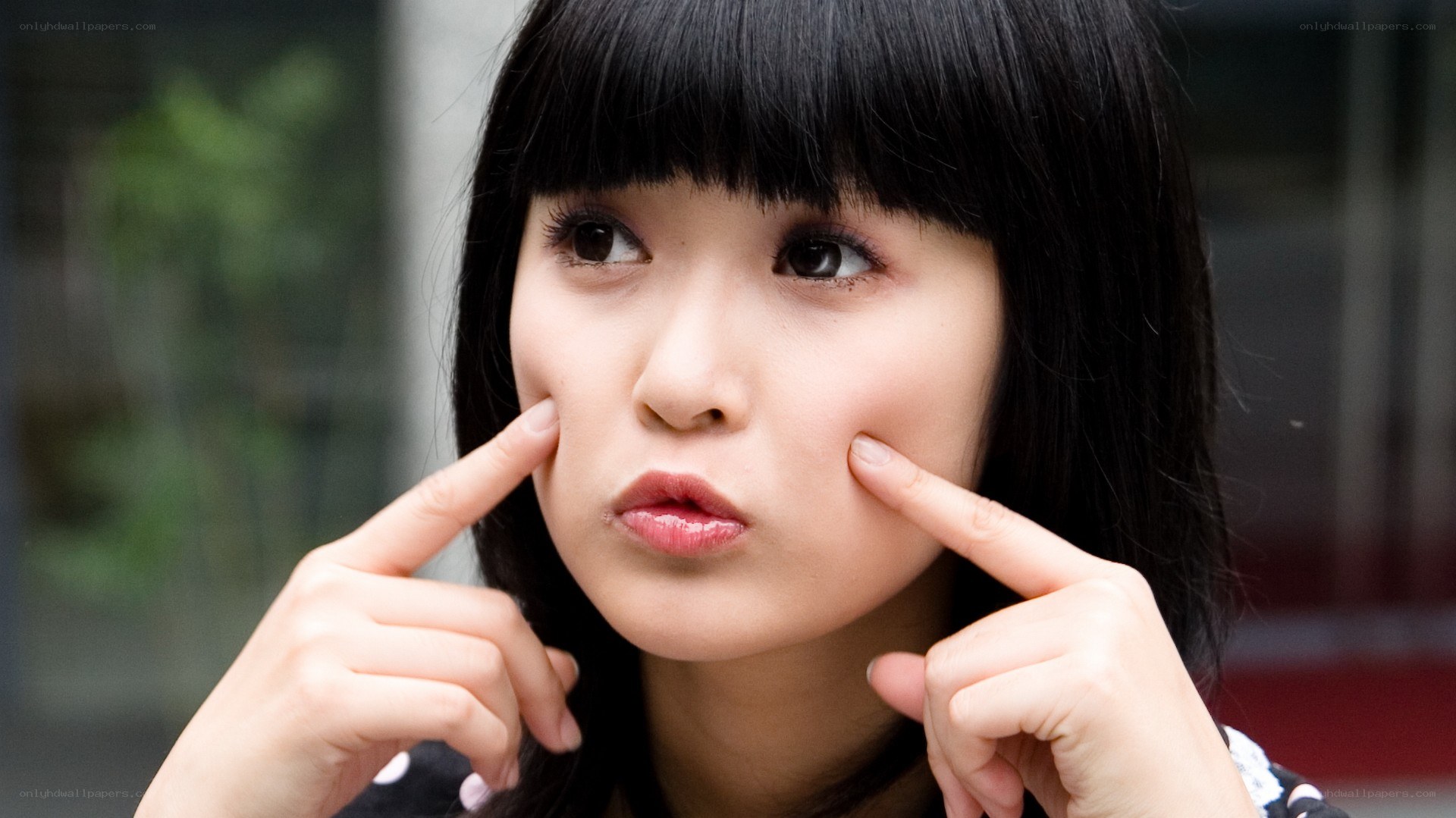 woman pinching cheeks
