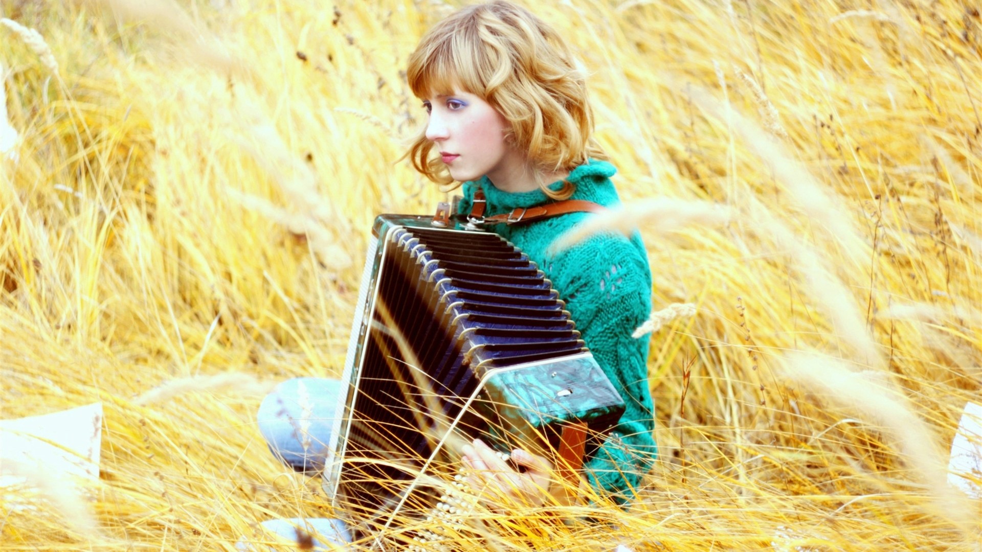 Woman playing accordion in field