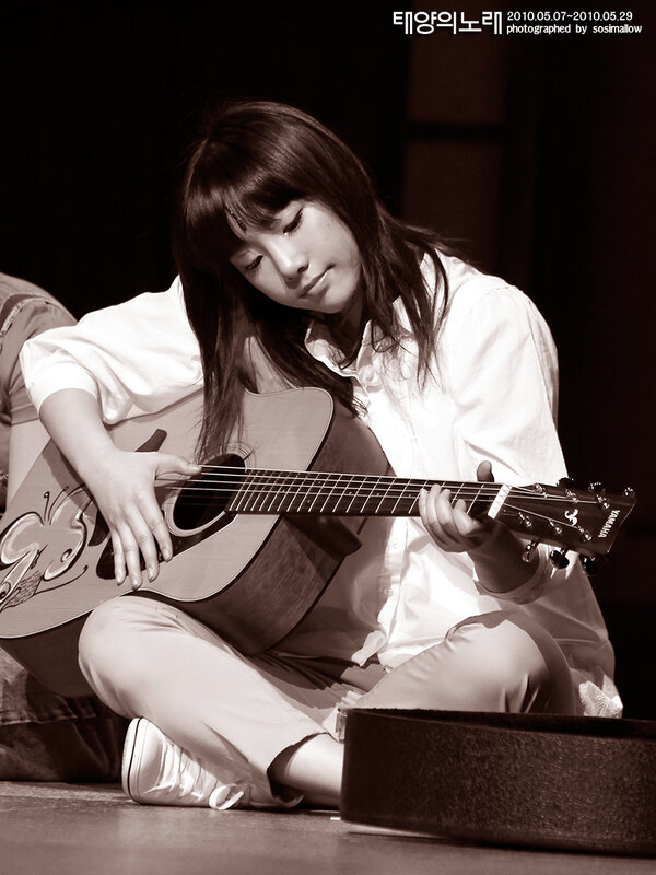 woman playing acoustic guitar