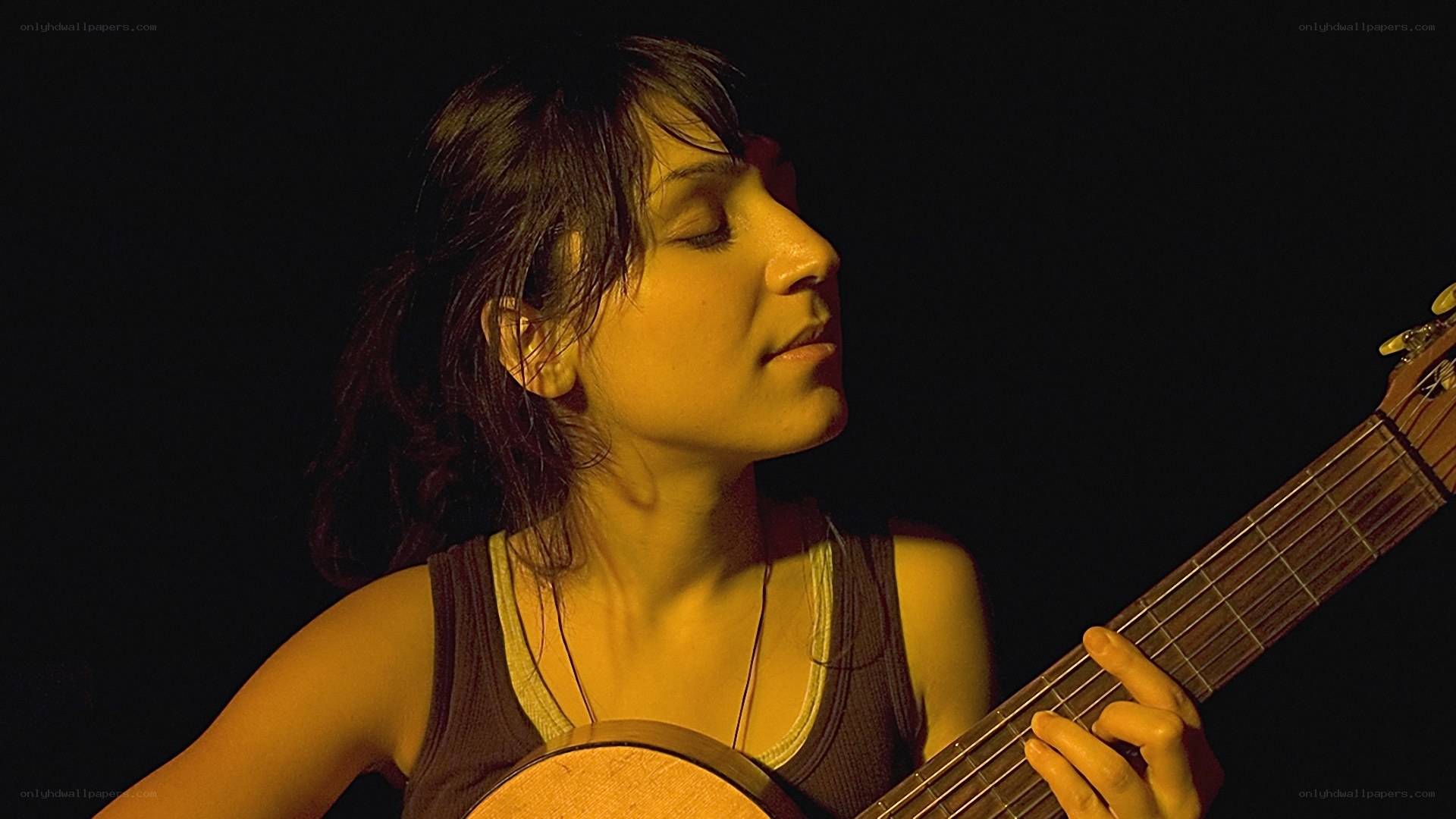 woman playing acoustic guitar