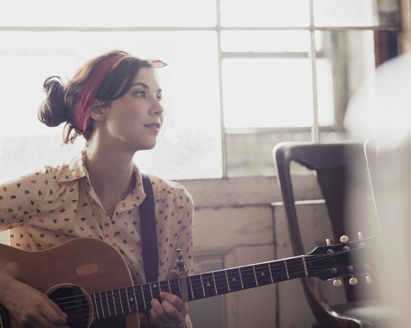 woman playing acoustic guitar