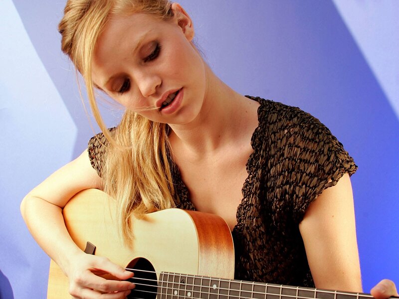 woman playing acoustic guitar