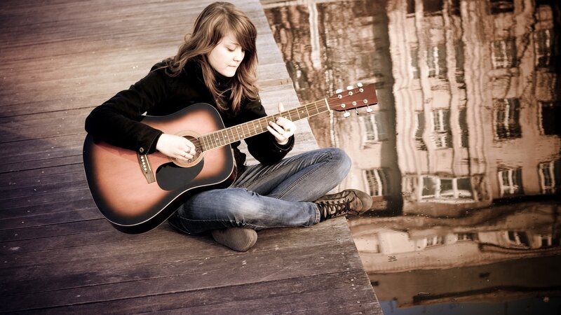 woman playing acoustic guitar