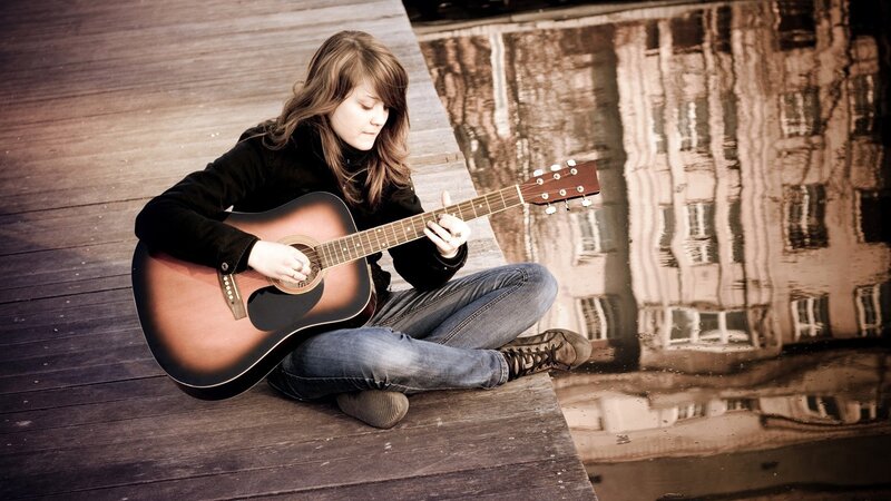 woman playing acoustic guitar