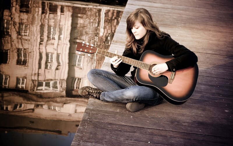 woman playing acoustic guitar