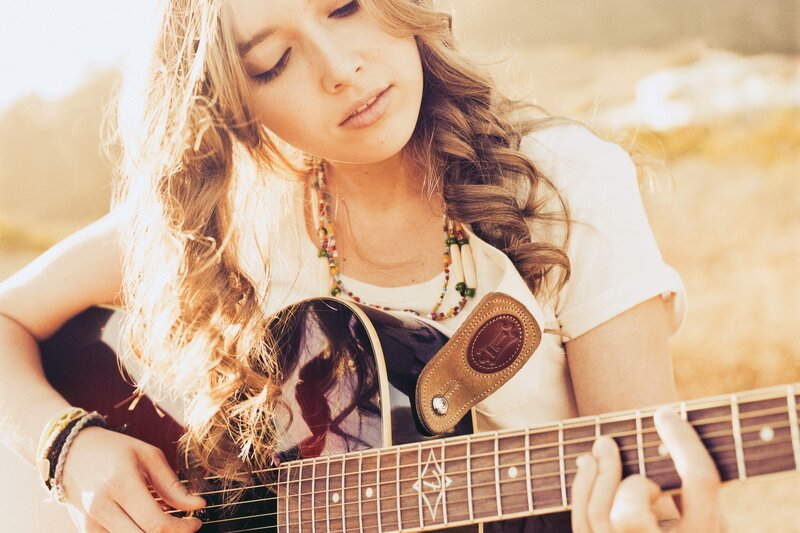 woman playing acoustic guitar