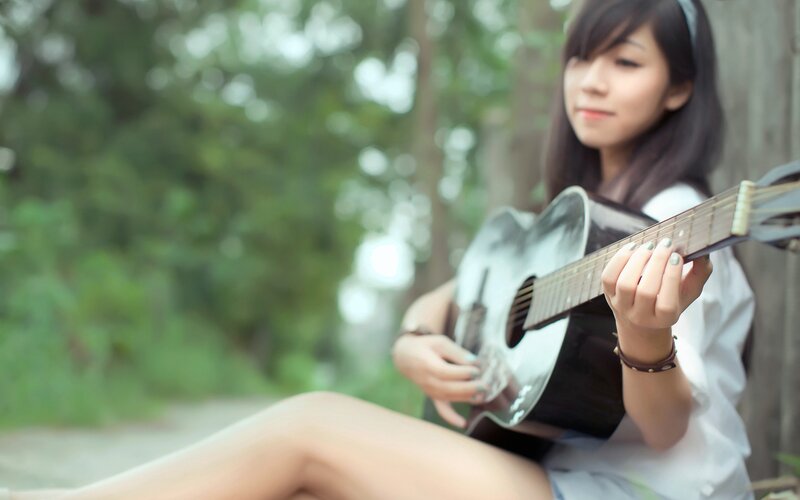 woman playing acoustic guitar