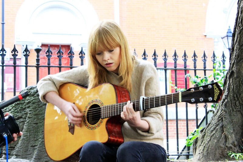 woman playing acoustic guitar