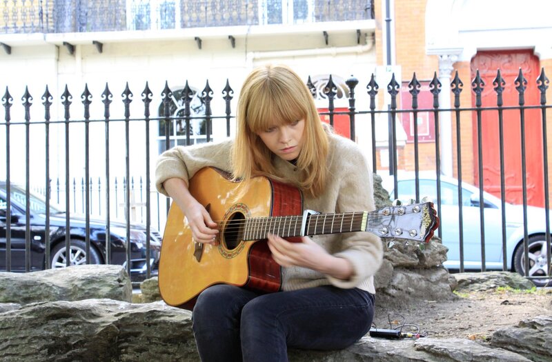 Woman playing acoustic guitar