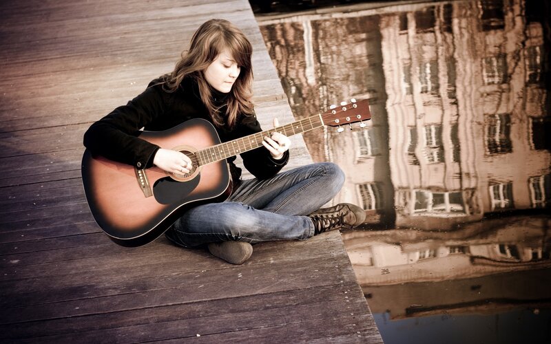 woman playing acoustic guitar